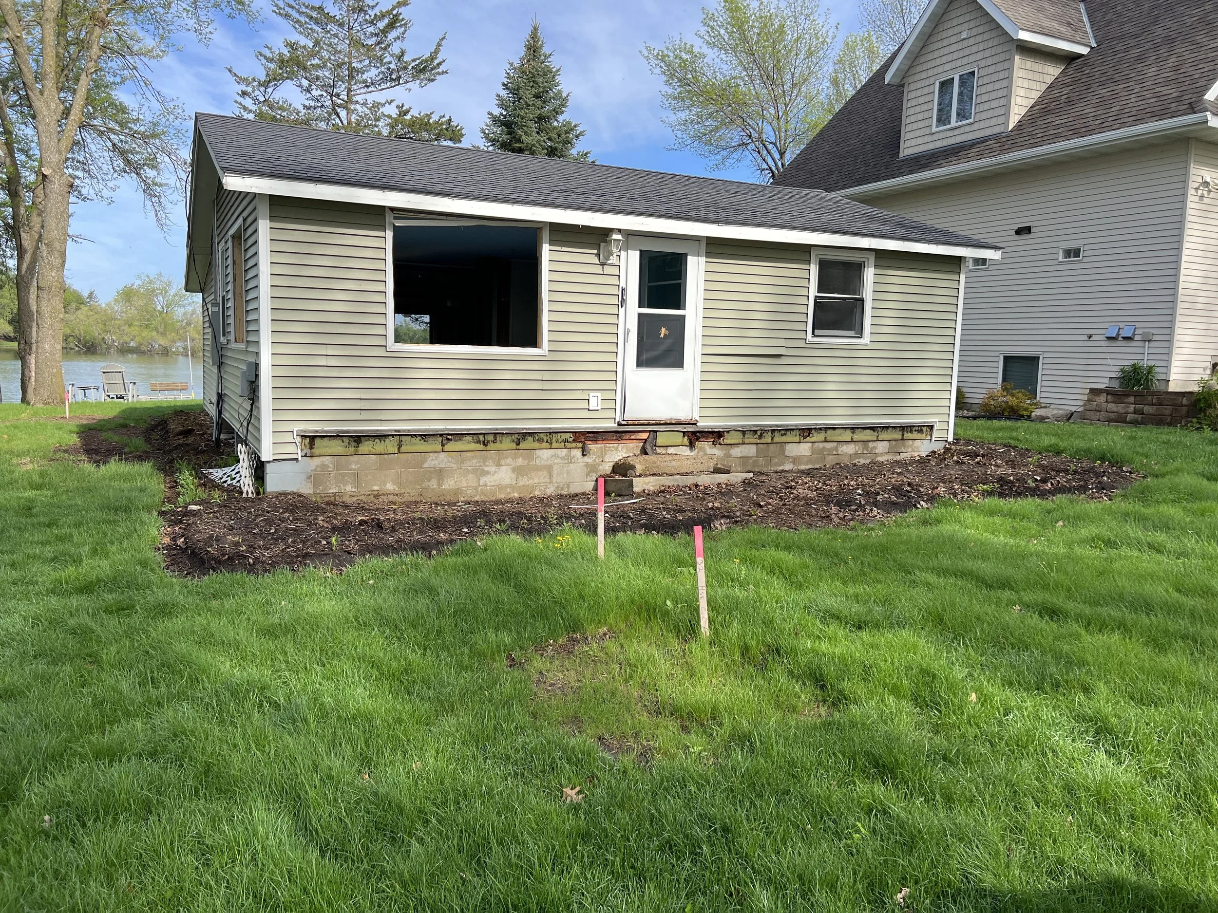 2 lake-home-before-rear-elevation-deck-removal-foundation-exposed.jpeg