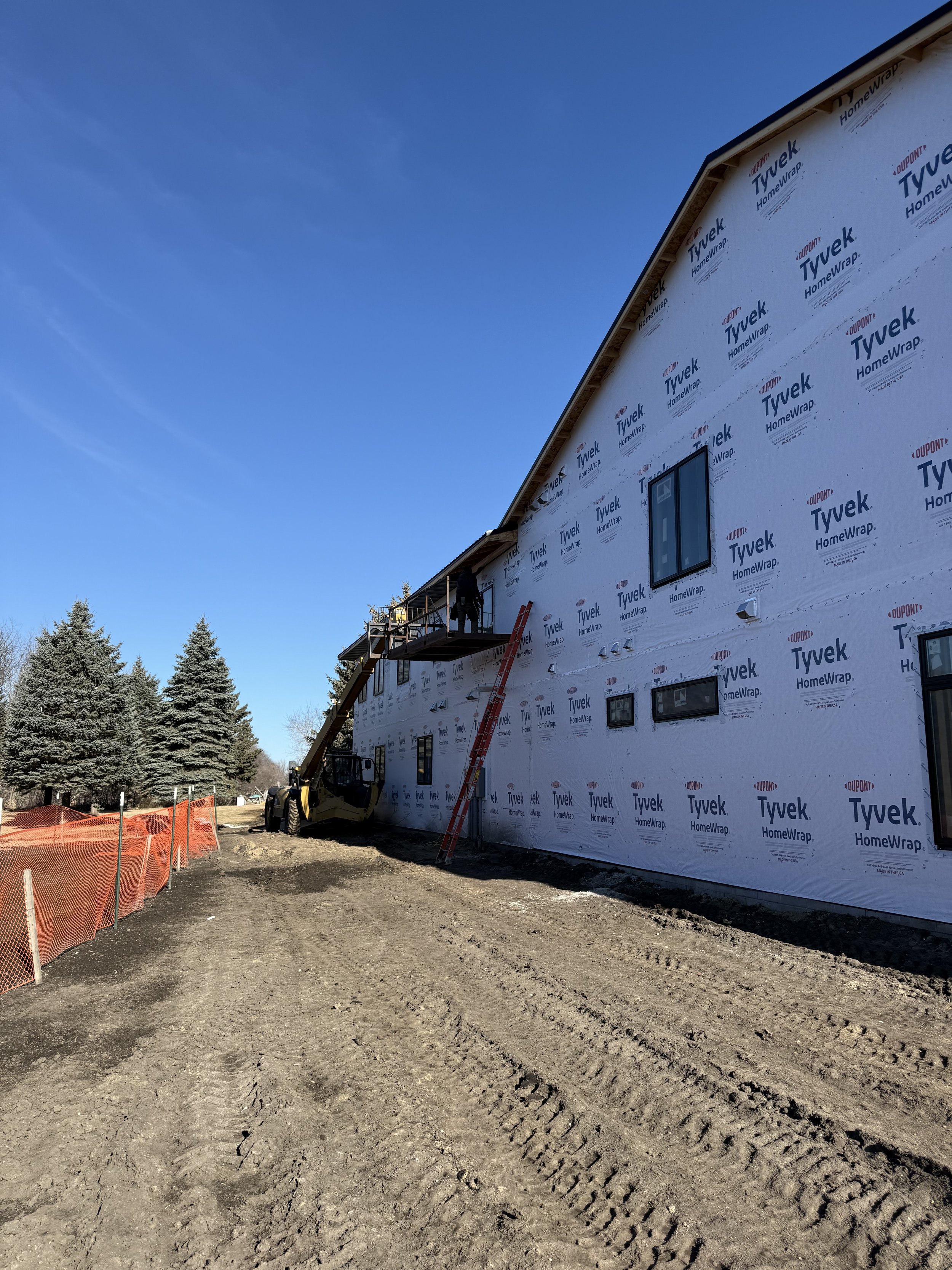 31 sprengeler-construction-barndominium-dark-siding-covered-entry.jpeg