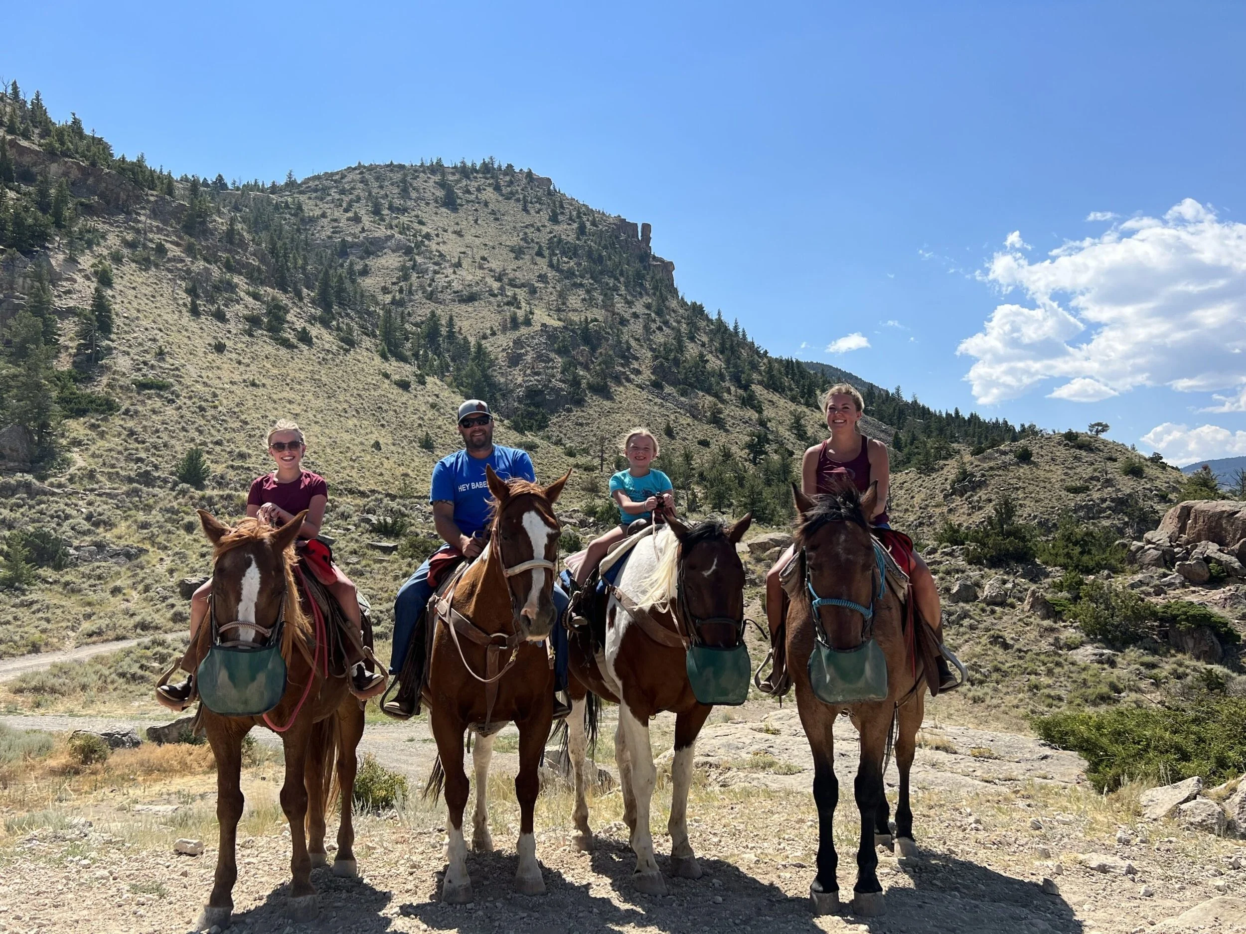 The Sprengeler Construction owners family horseback riding together in a scenic mountain landscape, representing strong family values and outdoor lifestyle