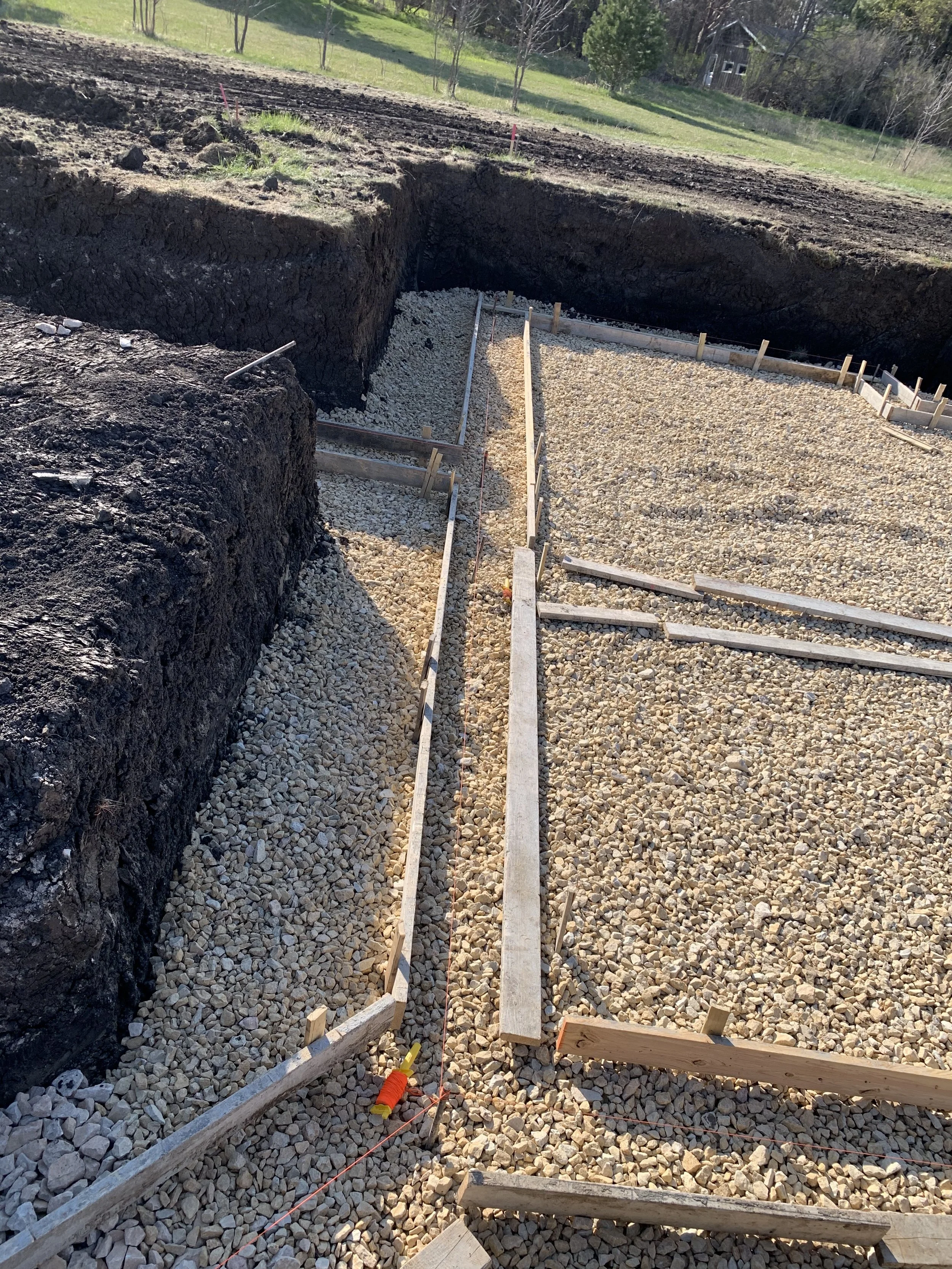 3 sprengeler-construction-footing-prep-gravel-base-foundation-layout.jpeg