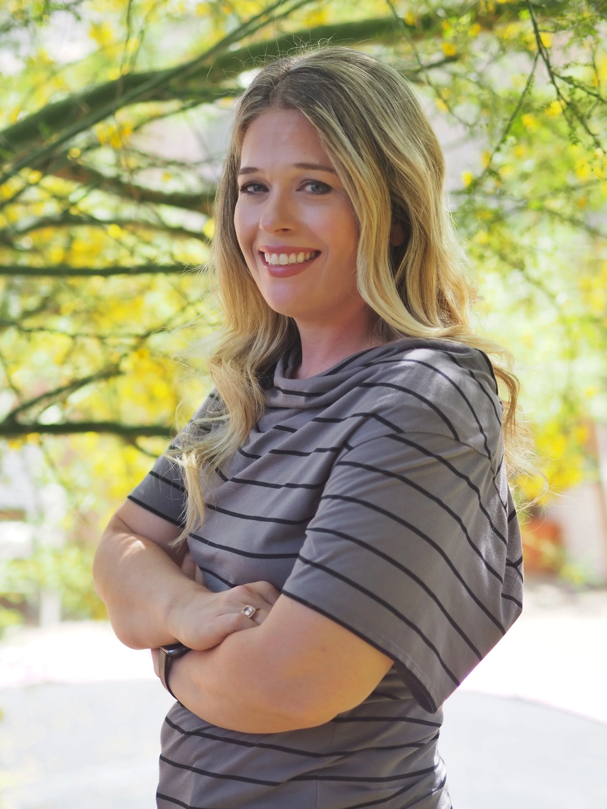Woman therapist standing in front of greenery