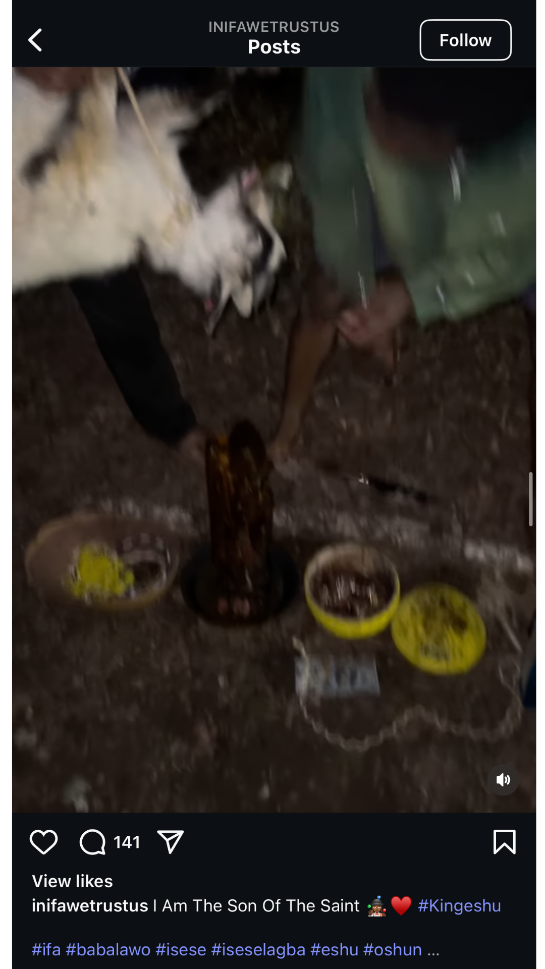 A person laying on the ground during a ritual or ceremony, surrounded by bowls filled with substances and objects, with an altar or central object in front of them, suggesting a spiritual or cultural practice.