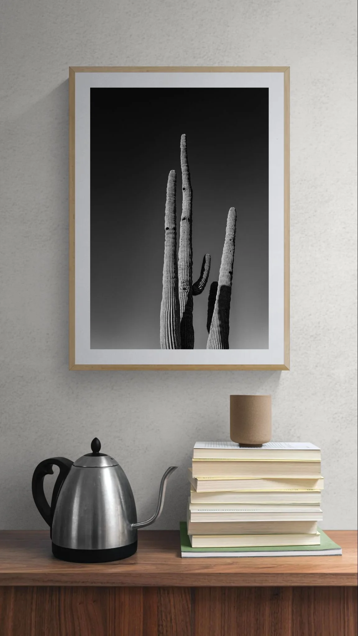 Close-up of books and a kettle on a cabinet.jpeg