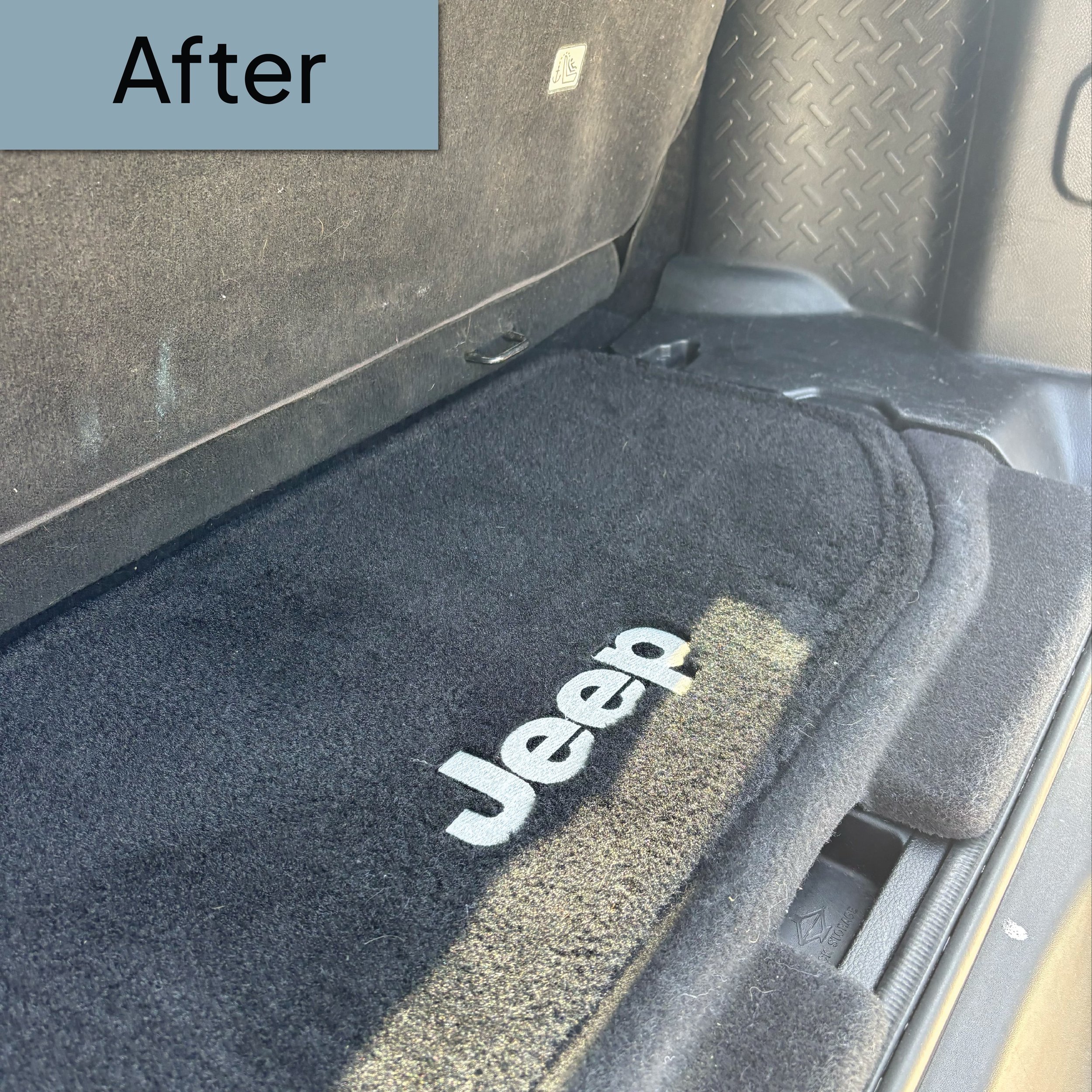 The image shows the back seat of a vehicle with a black carpeted floor, a portion of a black backrest, and a rubber mat with the word 'SRS' printed on it. There is also a small metal hook attached to the underside of the seat.
