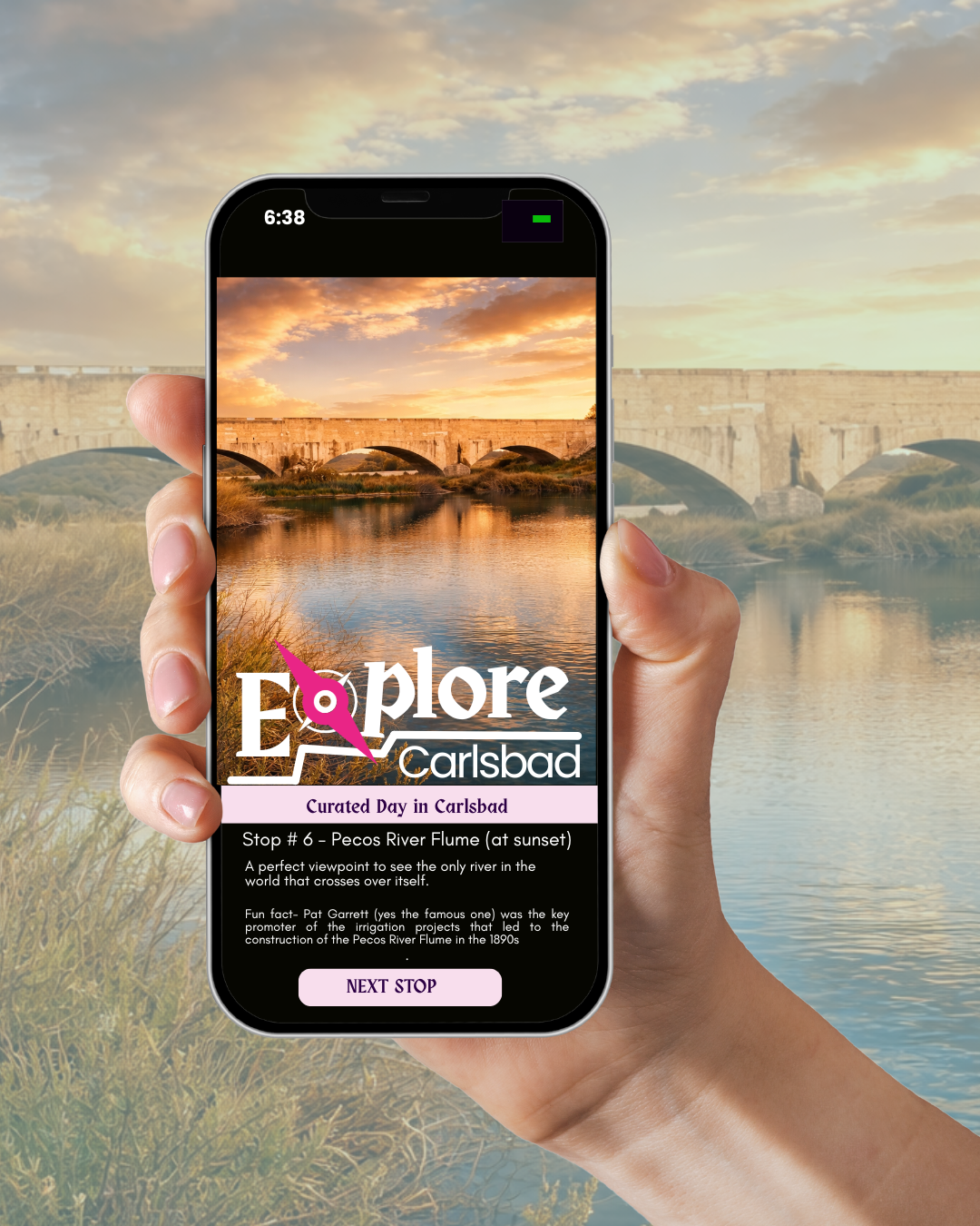 A person holding a smartphone displaying an app for exploring Carlsbad.