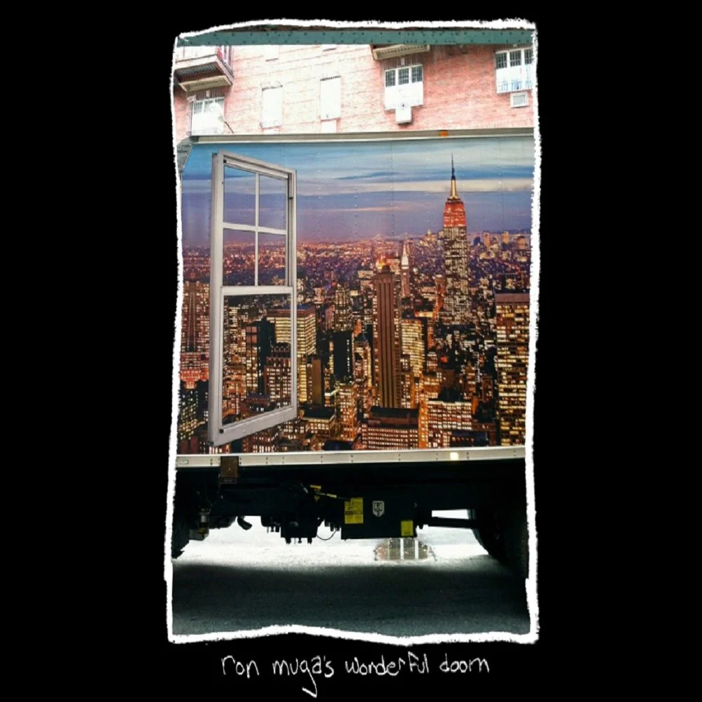 A truck with a city skyline mural of New York City, including the Empire State Building, is shown with an open window. The bottom of the truck has handwritten text reading "con mug's wonderful doom."