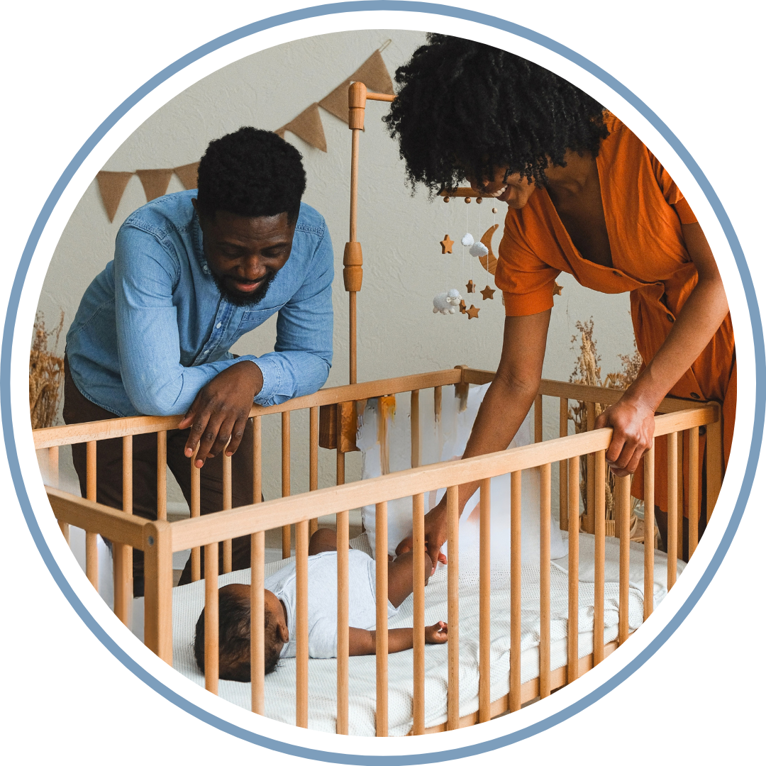 Parents offering consistent comfort to their baby in a wooden crib during bedtime routine