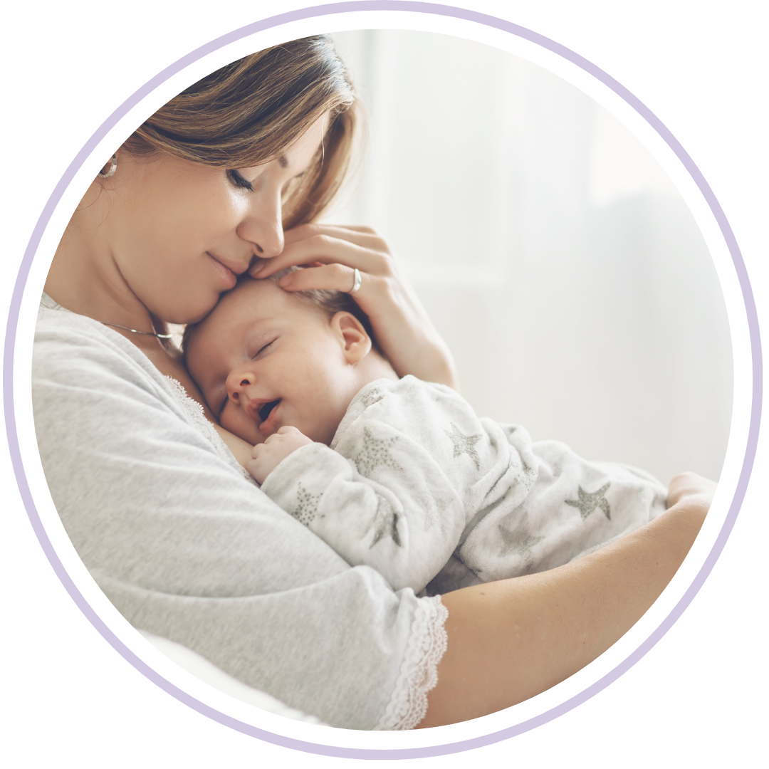 A mother in comfortable, casual clothing sitting in a cozy armchair, gently rocking her baby to sleep. The nursery has soft textures and a minimalist feel, highlighting a secure and low-intervention sleep environment