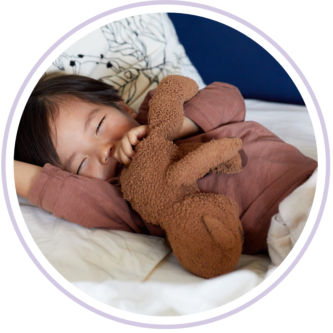 Toddler sleeping peacefully in bed while sucking their thumb to self-soothe