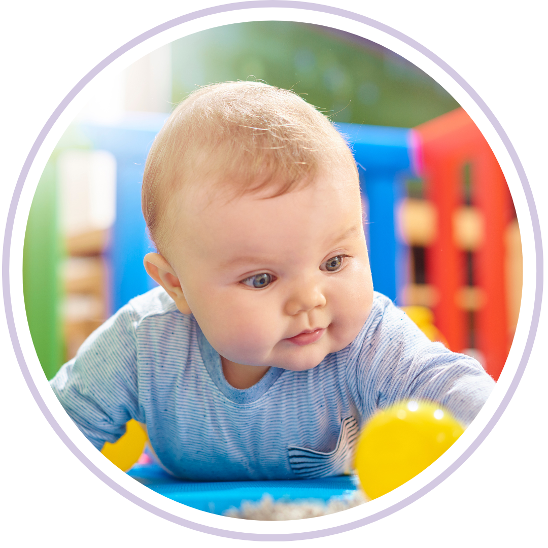 An infant practicing tummy time on a soft rug, illustrating the physical milestones that contribute to the 4-month sleep developmental shift in Shaker Heights