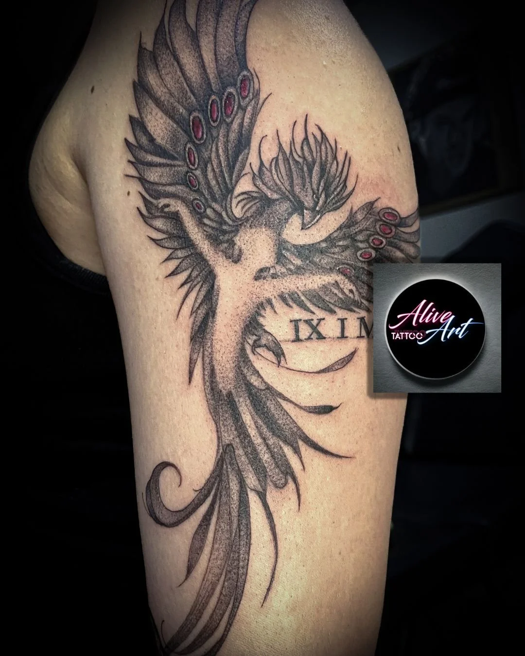 Black and gray tattoo of a phoenix with outstretched wings, a long tail, and the Roman numerals IX and IX written underneath.