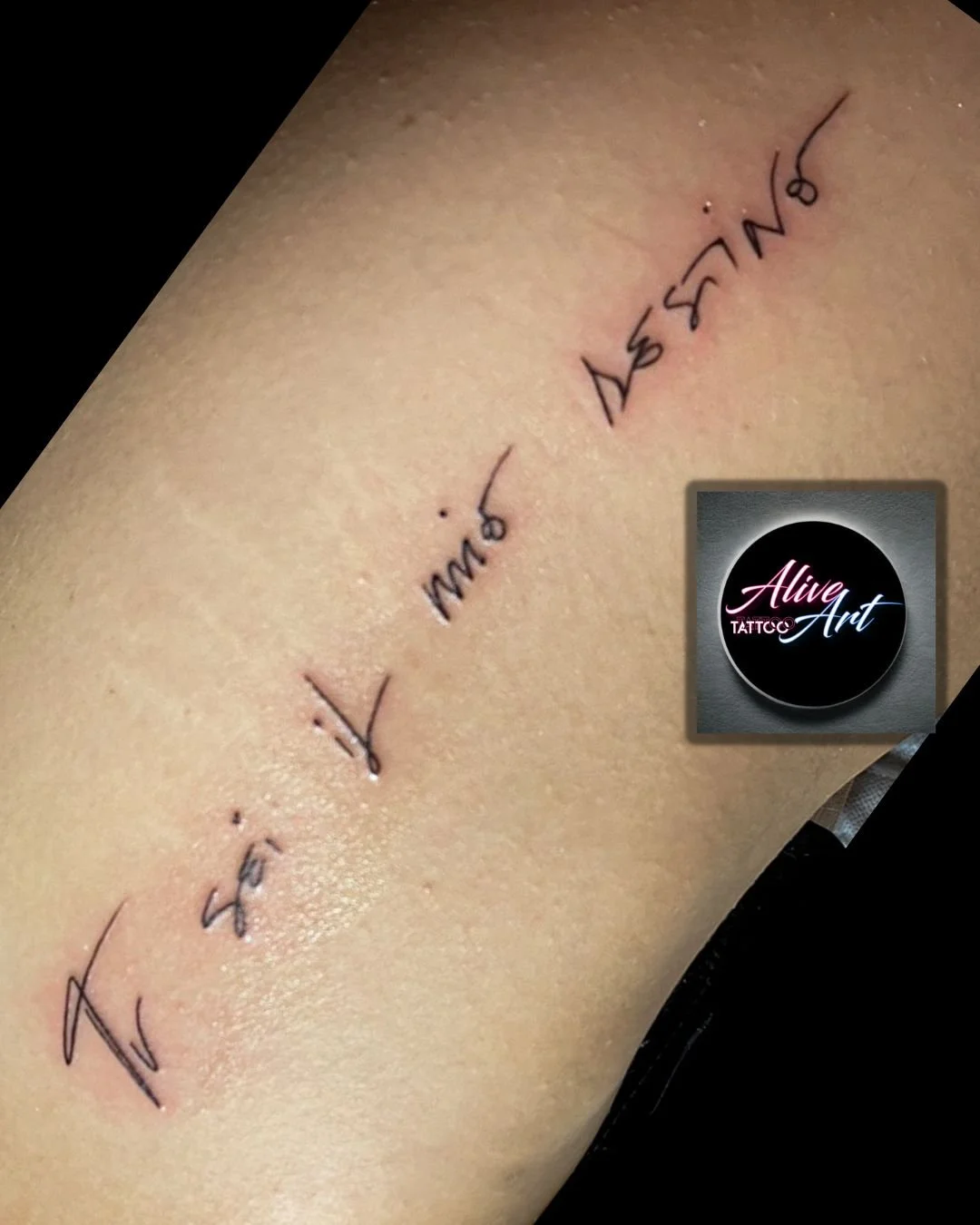 A tattoo on skin with black ink, displaying the words "Live, Laugh, Love" in a cursive and handwritten style.
