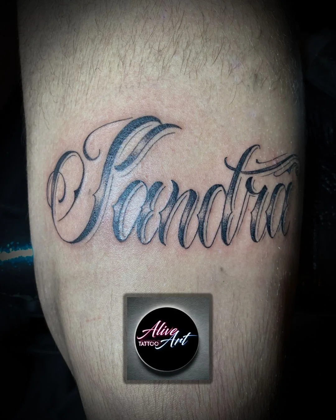 Tattoo of the name 'Fayanda' in elegant cursive script on skin.
