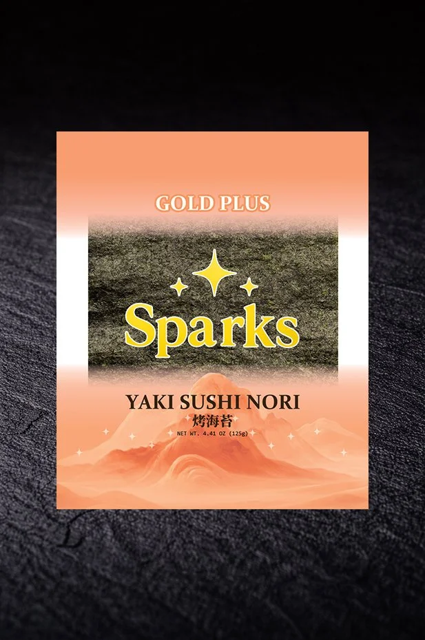 Packaging of Sparks Gold Plus Yaki Sushi Nori seaweed, featuring a peach-colored background with star and mountain graphics, and text in English and Japanese.