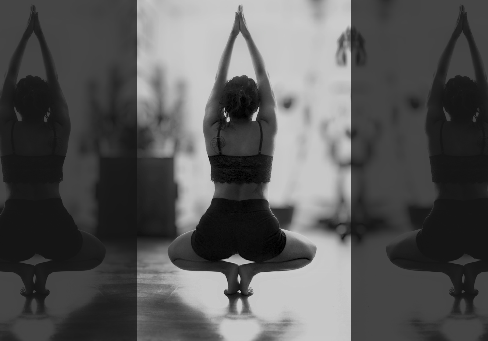 Person practicing yoga on a mat with patterned pants and plants in the background.