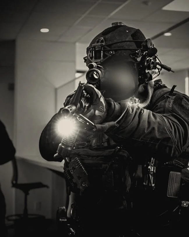 Operator clearing an office with a weapon-mounted light