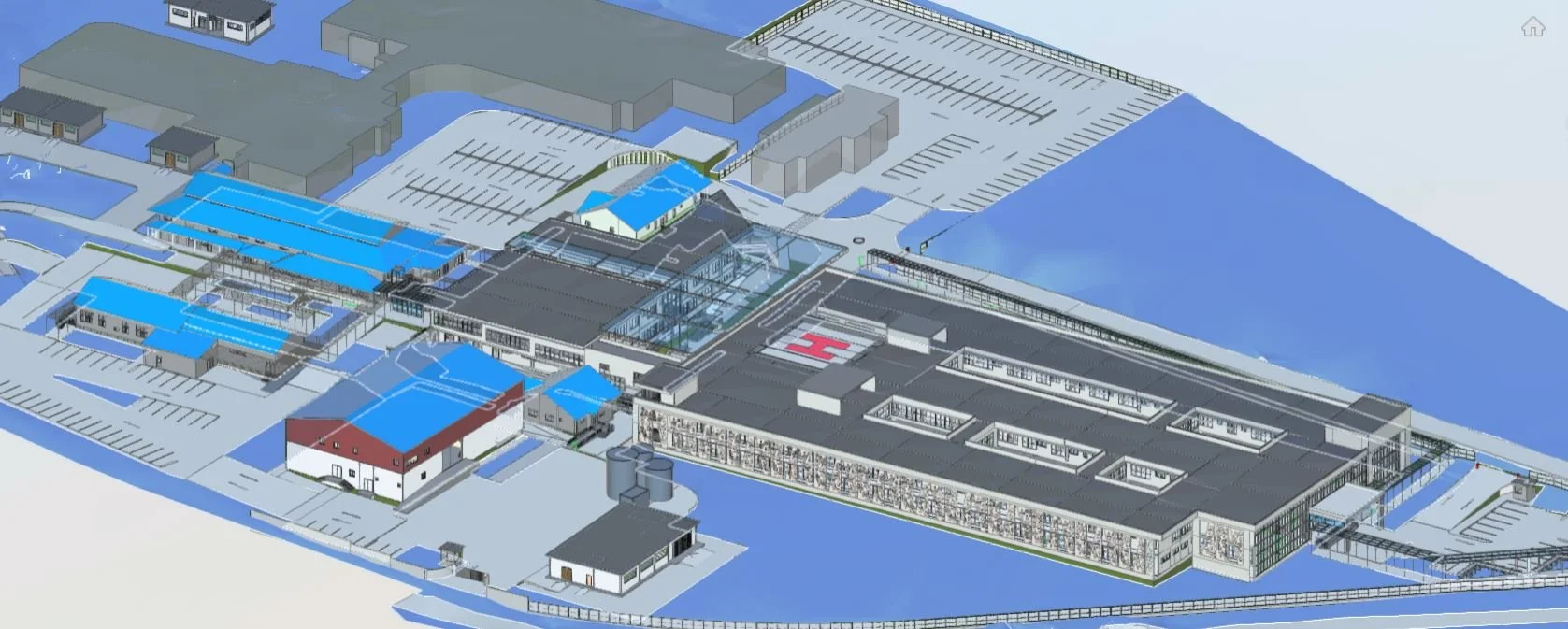 Plan architectural d'un centre médical ou hospitalier avec plusieurs bâtiments, zones de stationnement, helipad et installations diverses.