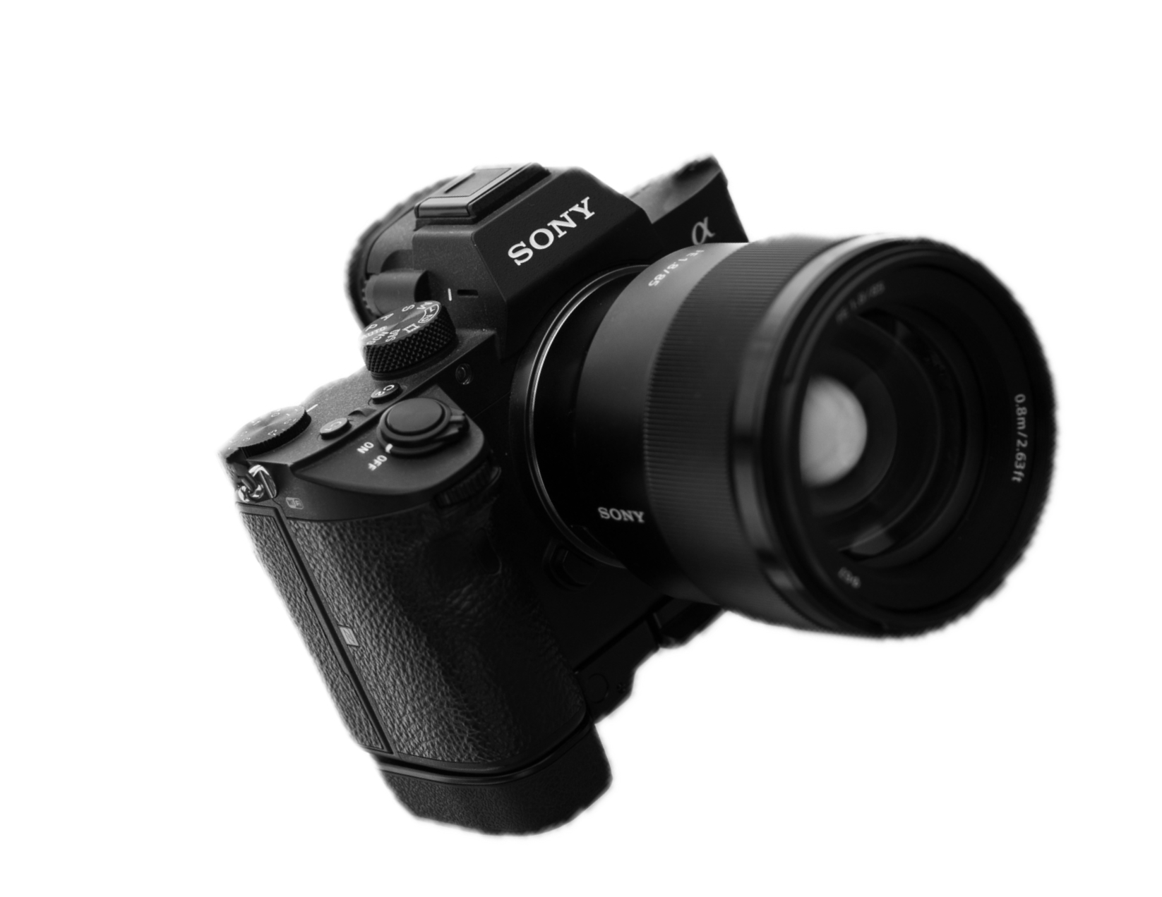 Black Sony mirrorless camera with attached zoom lens, viewed from an angle against a black background.