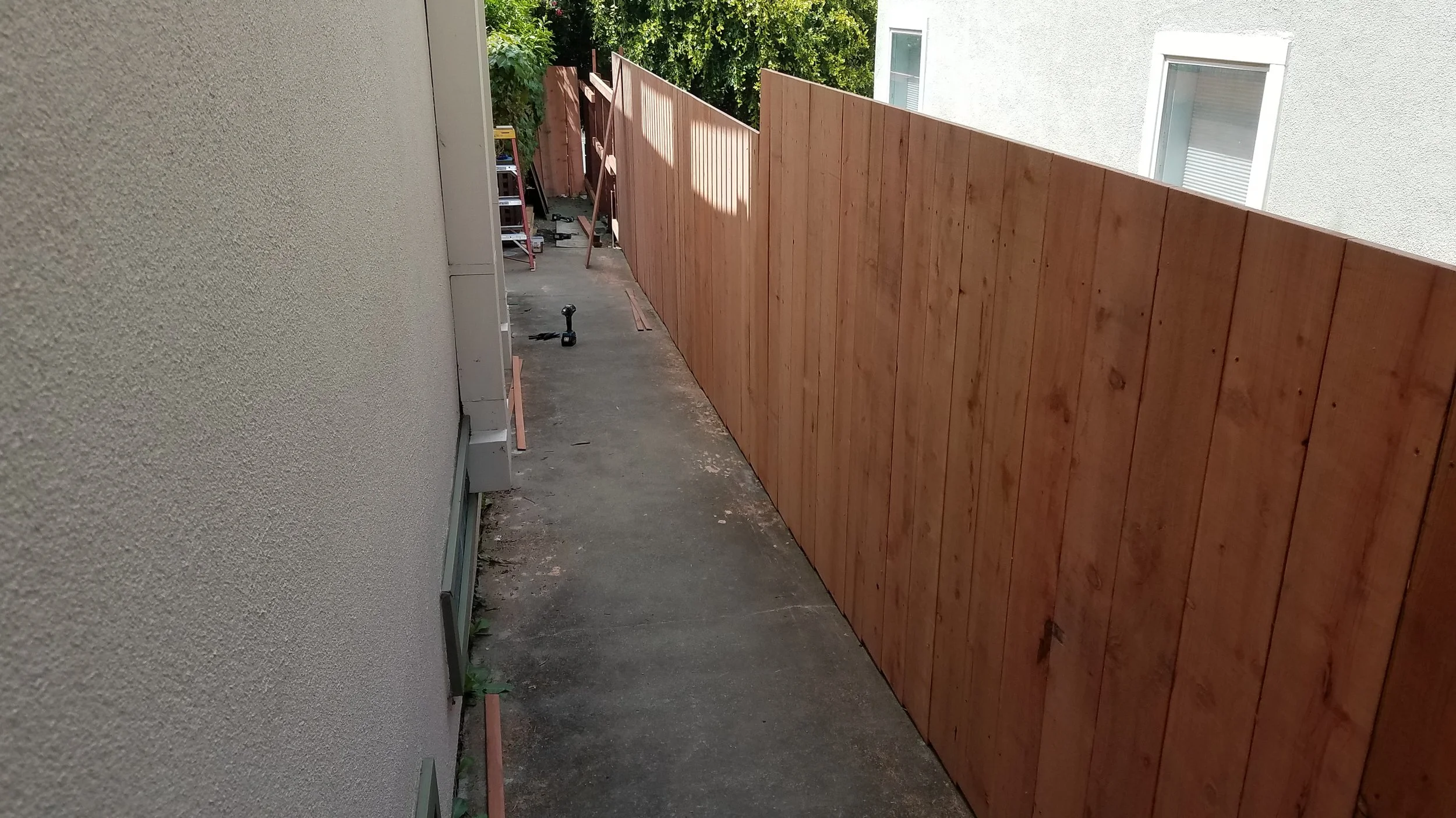 Redwood fence on top of a retaining wall in the Oakland Hills.