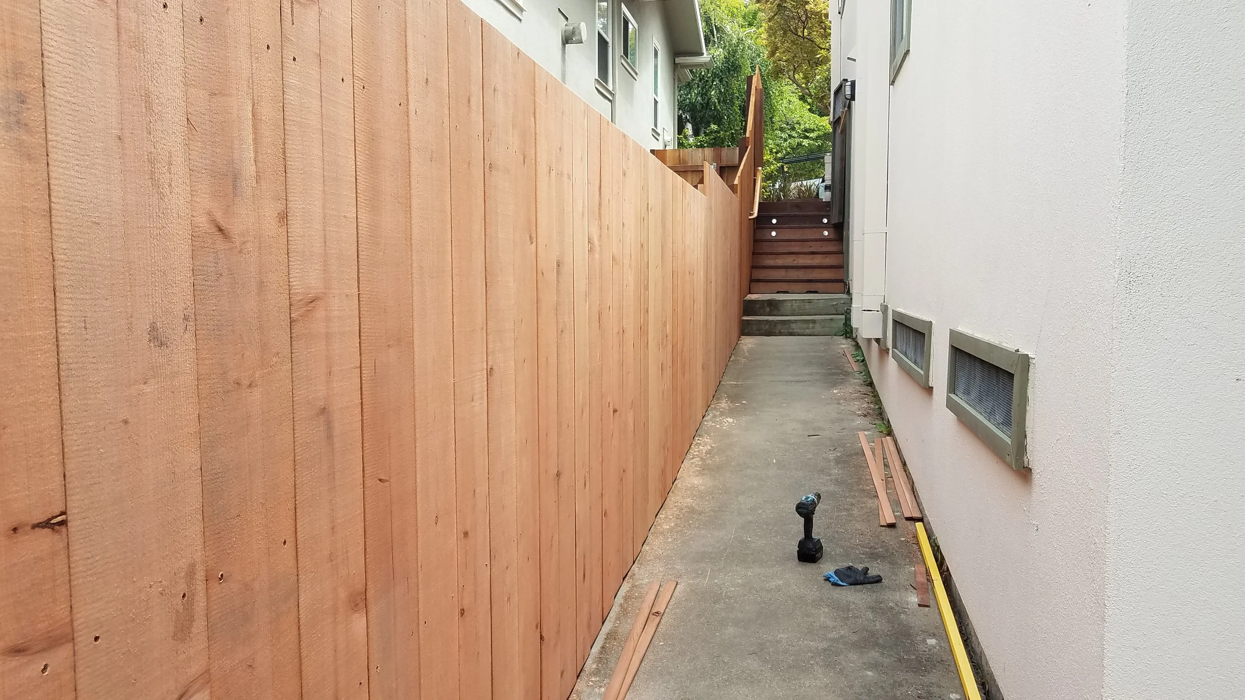 Redwood fence on top of a retaining wall in the Oakland Hills.