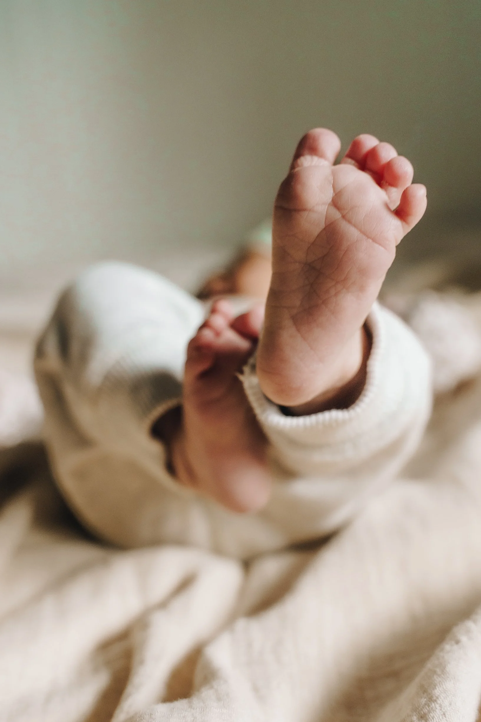 Close-up of a baby's tiny hand reaching out.