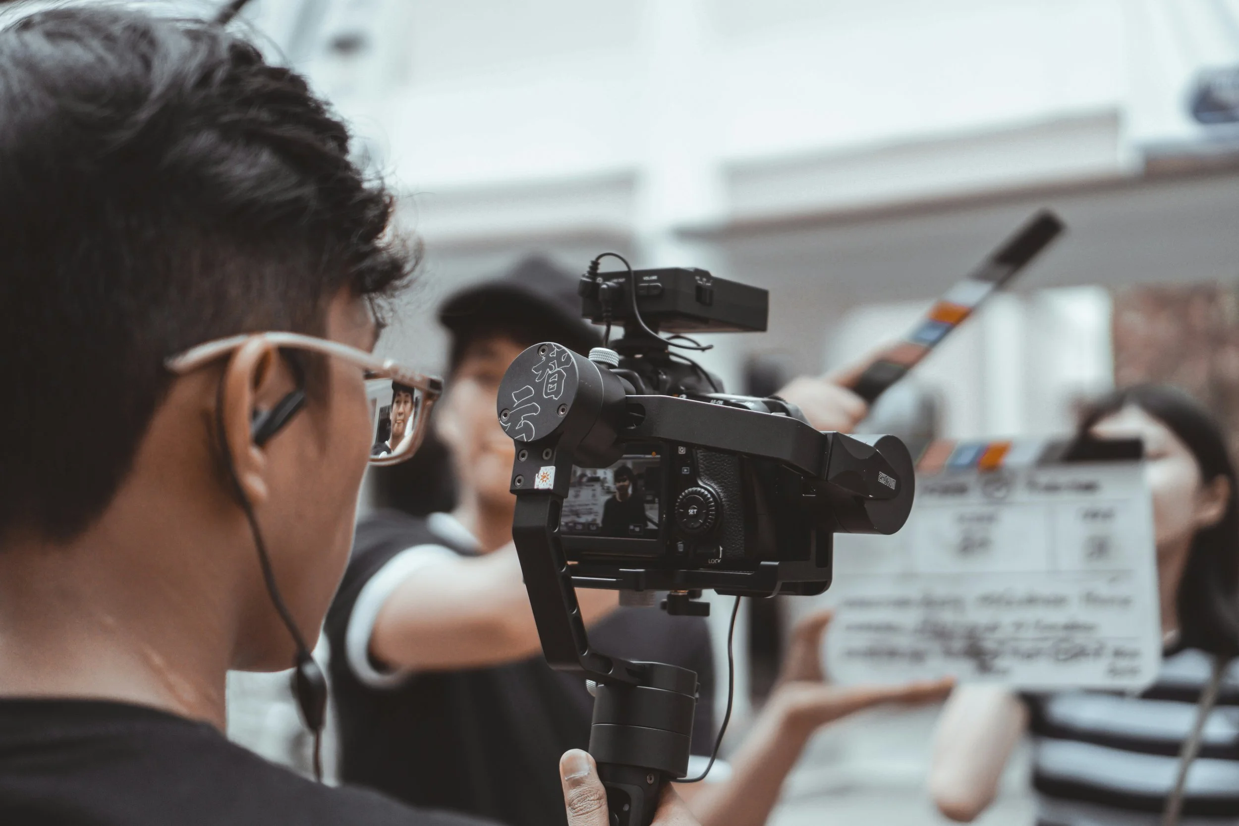 a camera operator filming a success case using a gimbal and framing a cinematic scene