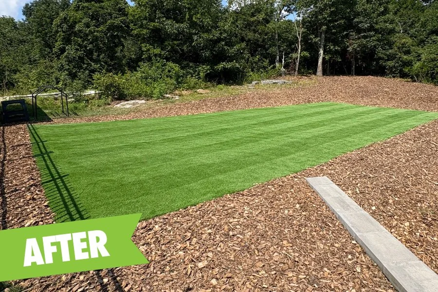 Turf feature installed with new grading and low-maintenance wood chips.