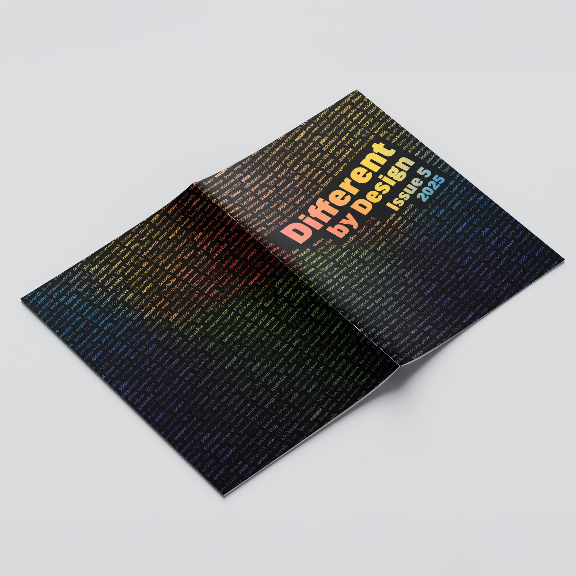 Open magazine titled "Different by Design Issue 5 2025" on a white surface, featuring colorful text and design elements.