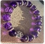 Purple beaded bracelet on a flat surface.