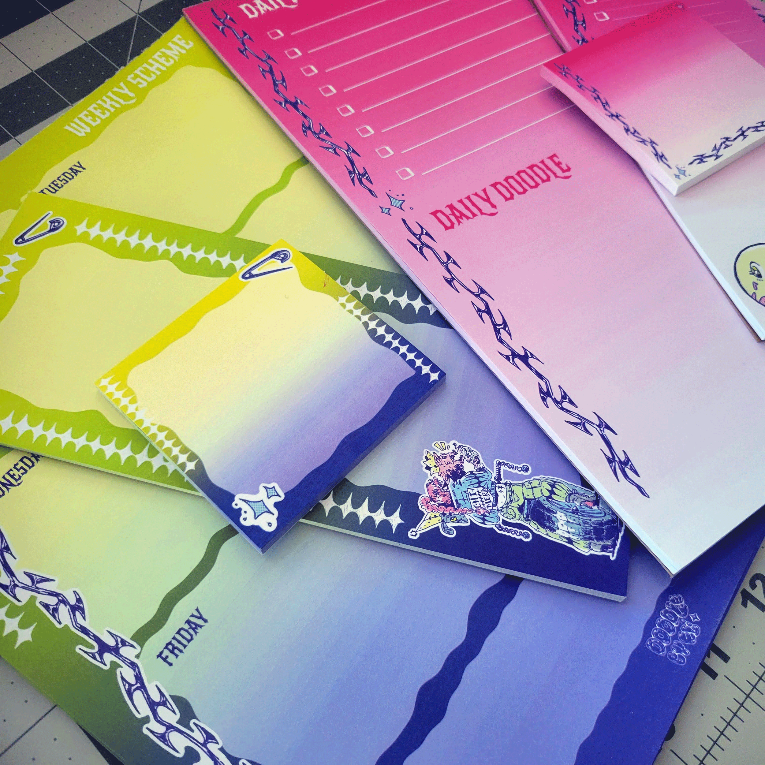 Colorful weekly planner pages in pink, yellow, blue, and purple with decorative borders and checkboxes for daily tasks.