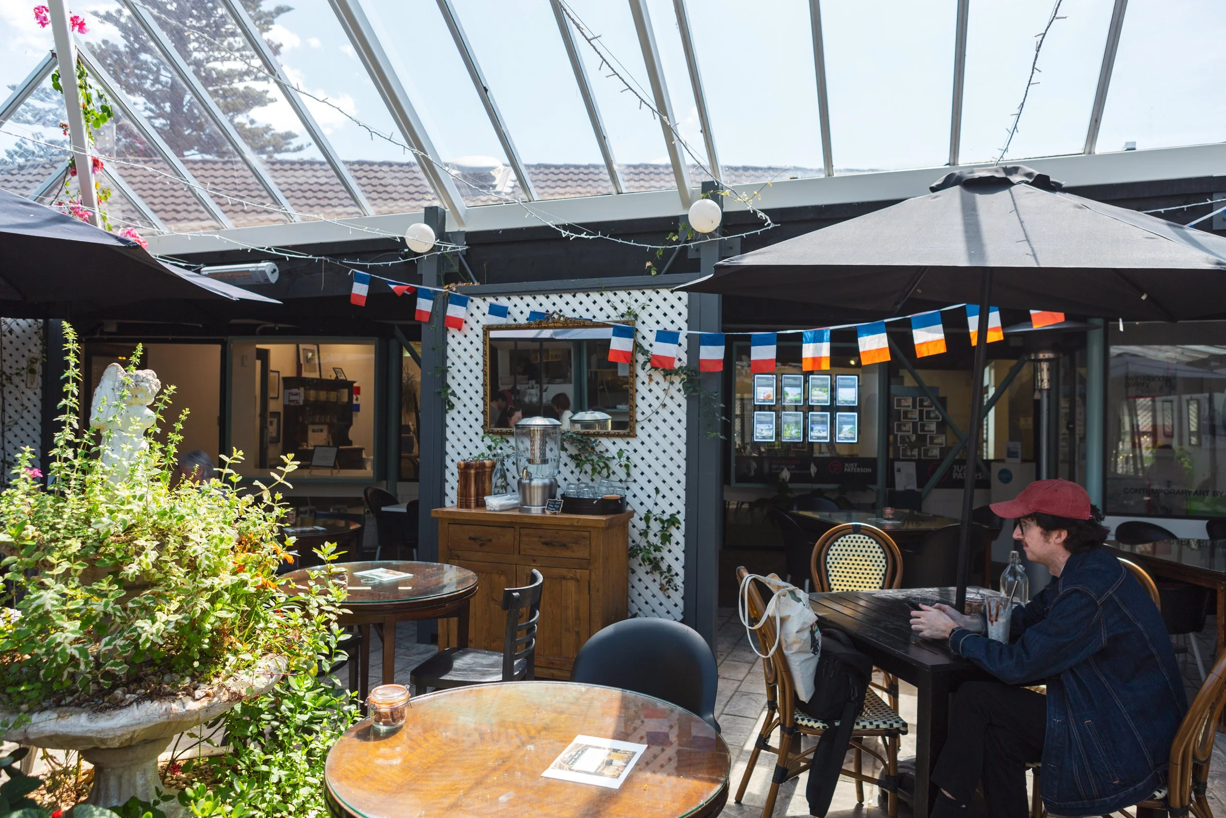 Covered seating area of Tartines Cafe, located in Eastbourne, Hutt Valley