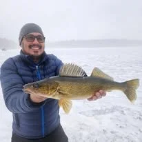 guided ice fishing trips just north of the frozen tundra of Lambeau Field. Chasing northern Wisconsin gold walleye