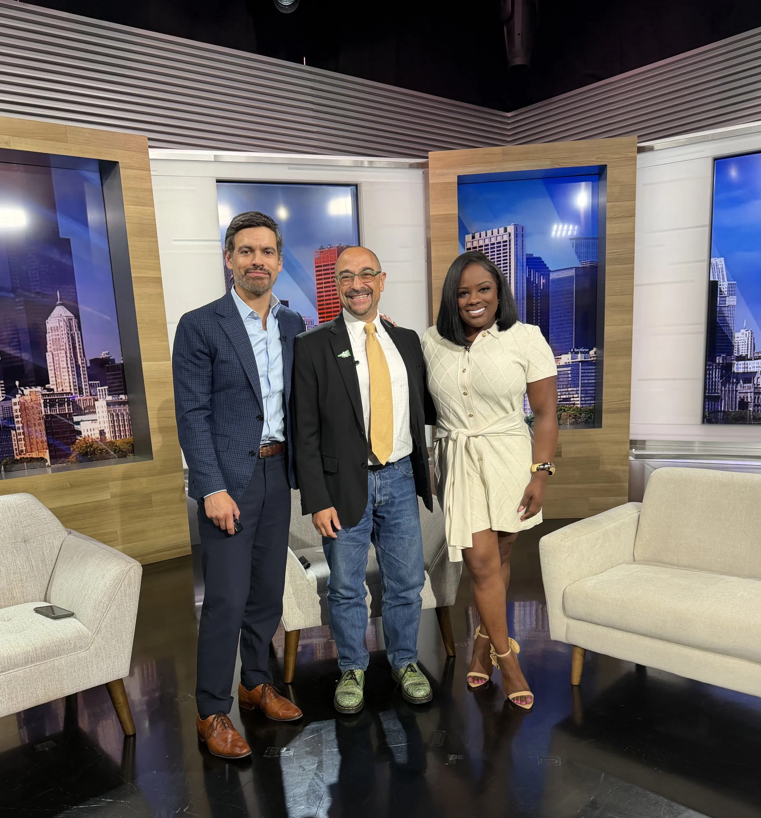 Two Chicago news anchors standing together with Edmond Yomtoob in a TV studio,  discussing mental health .
