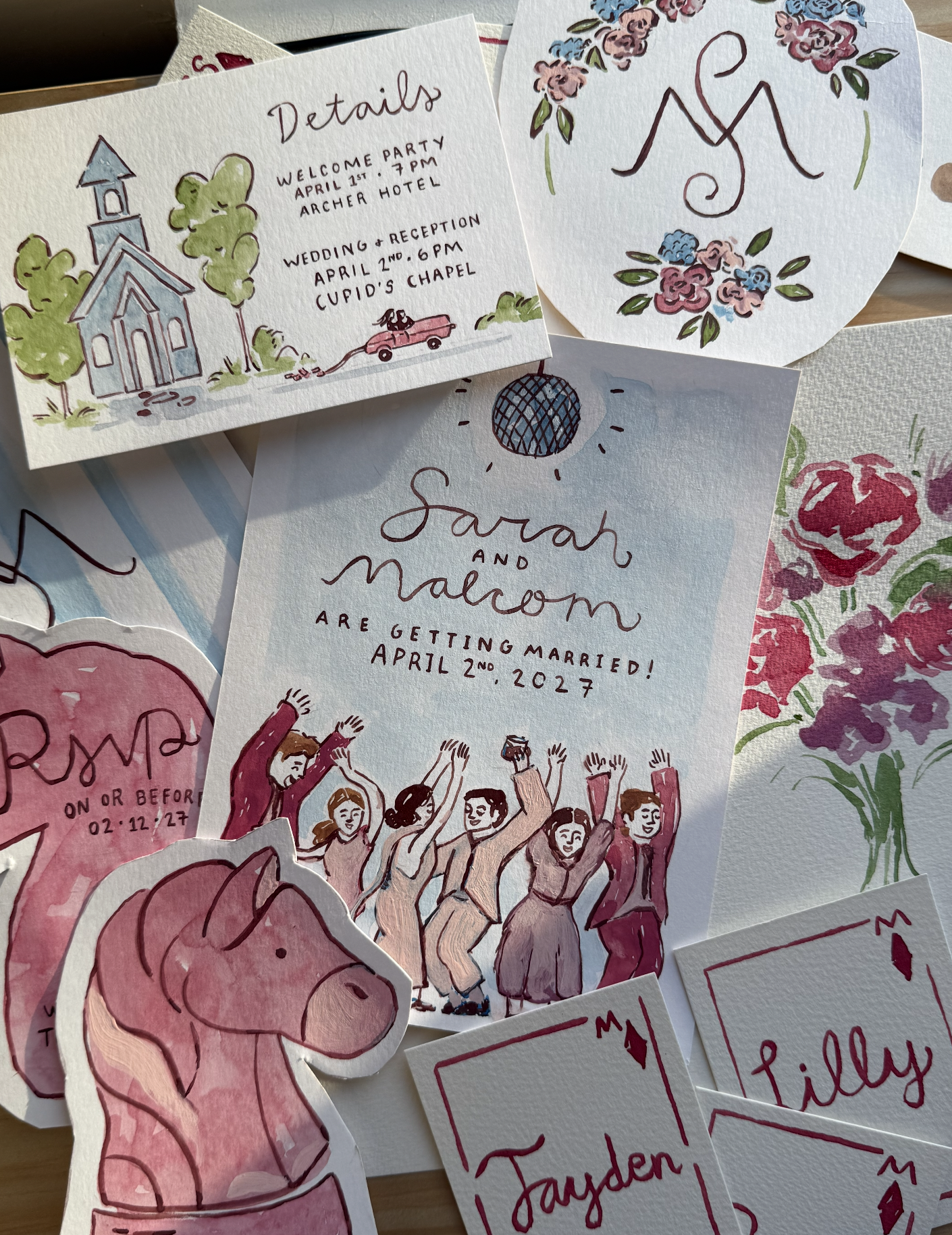 Collection of watercolor and ink hand-drawn stationery including an invitation with trees and a car, a floral monogram, a wedding announcement with a disco ball and dancing people, a pink unicorn sticker, and name tags for Jayden, Lilly, and Lily.