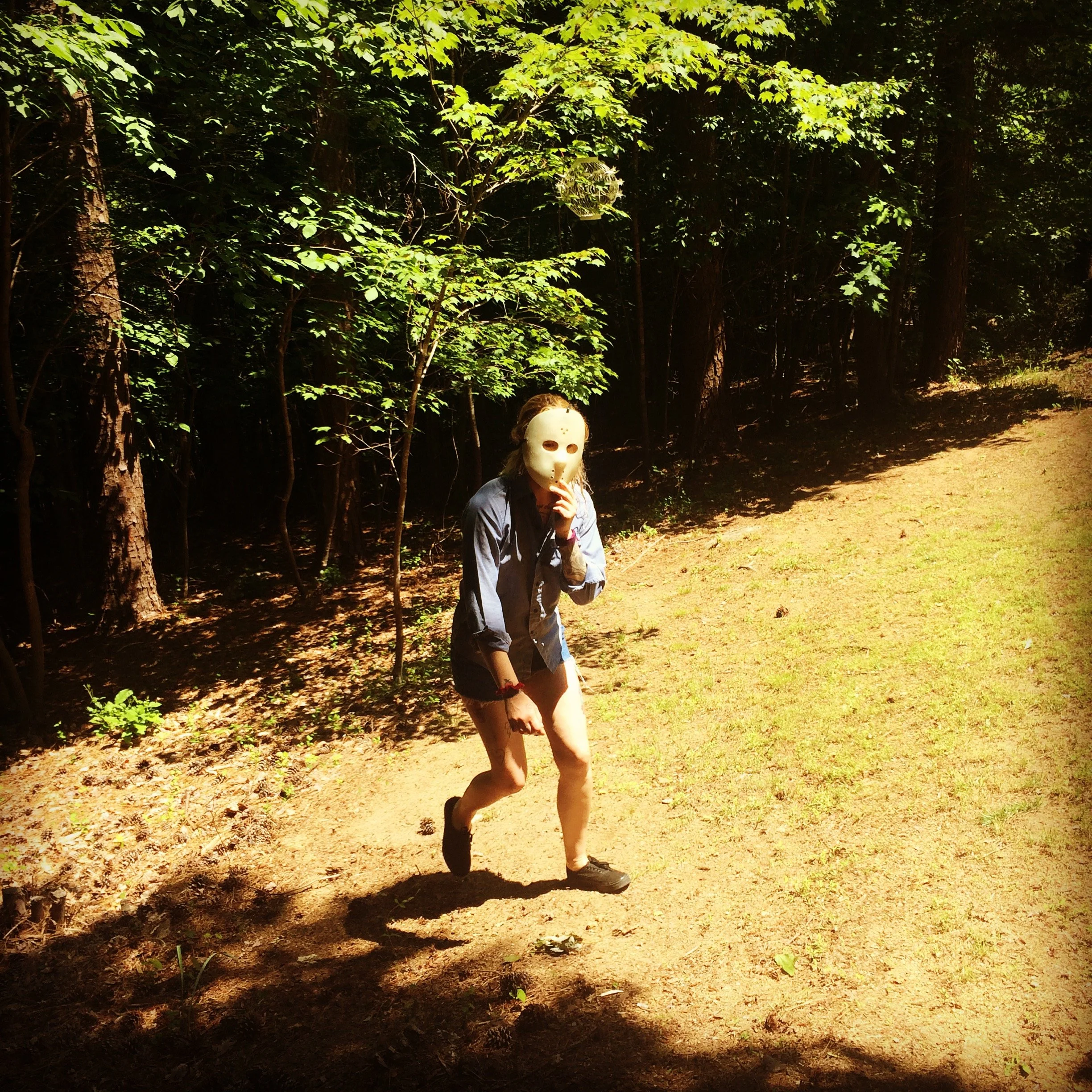 Adele emerges from the woods in a murder mask.