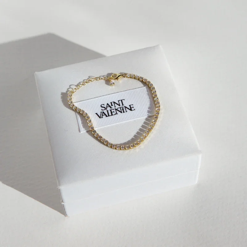 UpdatedAspenTennisBraceletFlatlayGoldSquare.webp