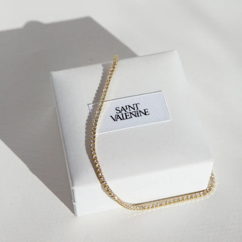 UpdatedAspenTennisNecklaceFlatlayGoldSquare.webp