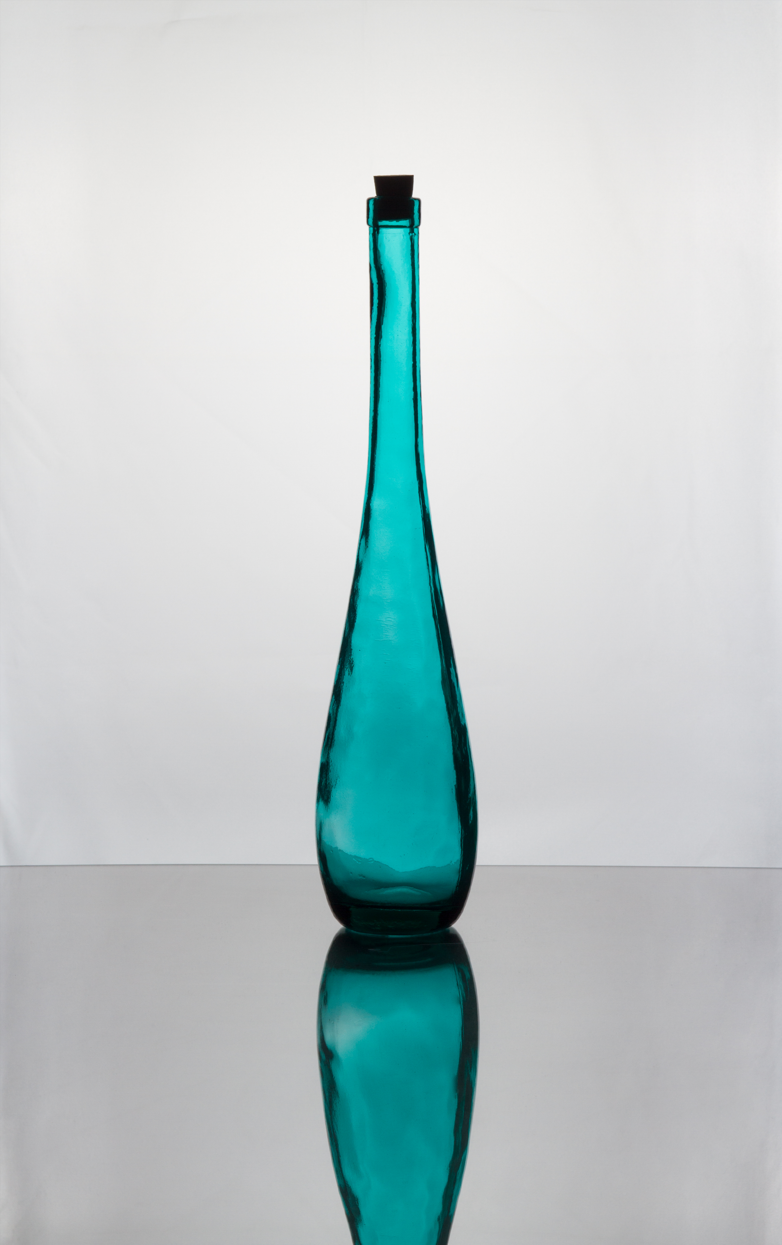 Tall green glass collectable bottle.