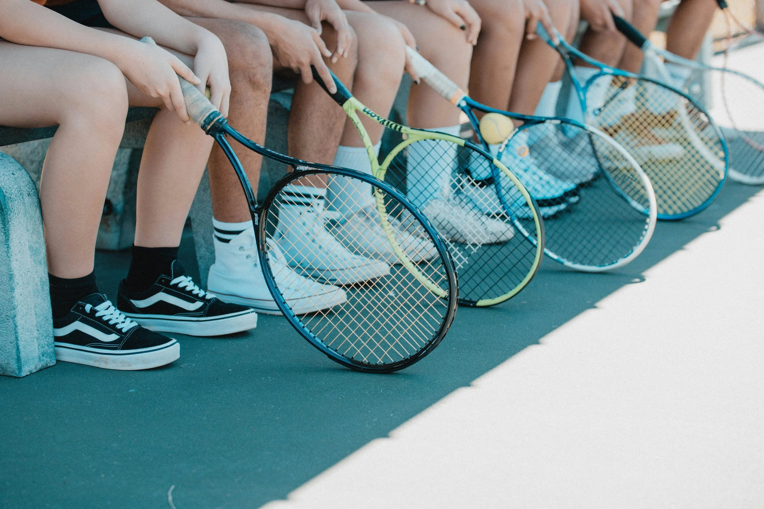 a collection of tennis player showing their tennis shoes and rackets