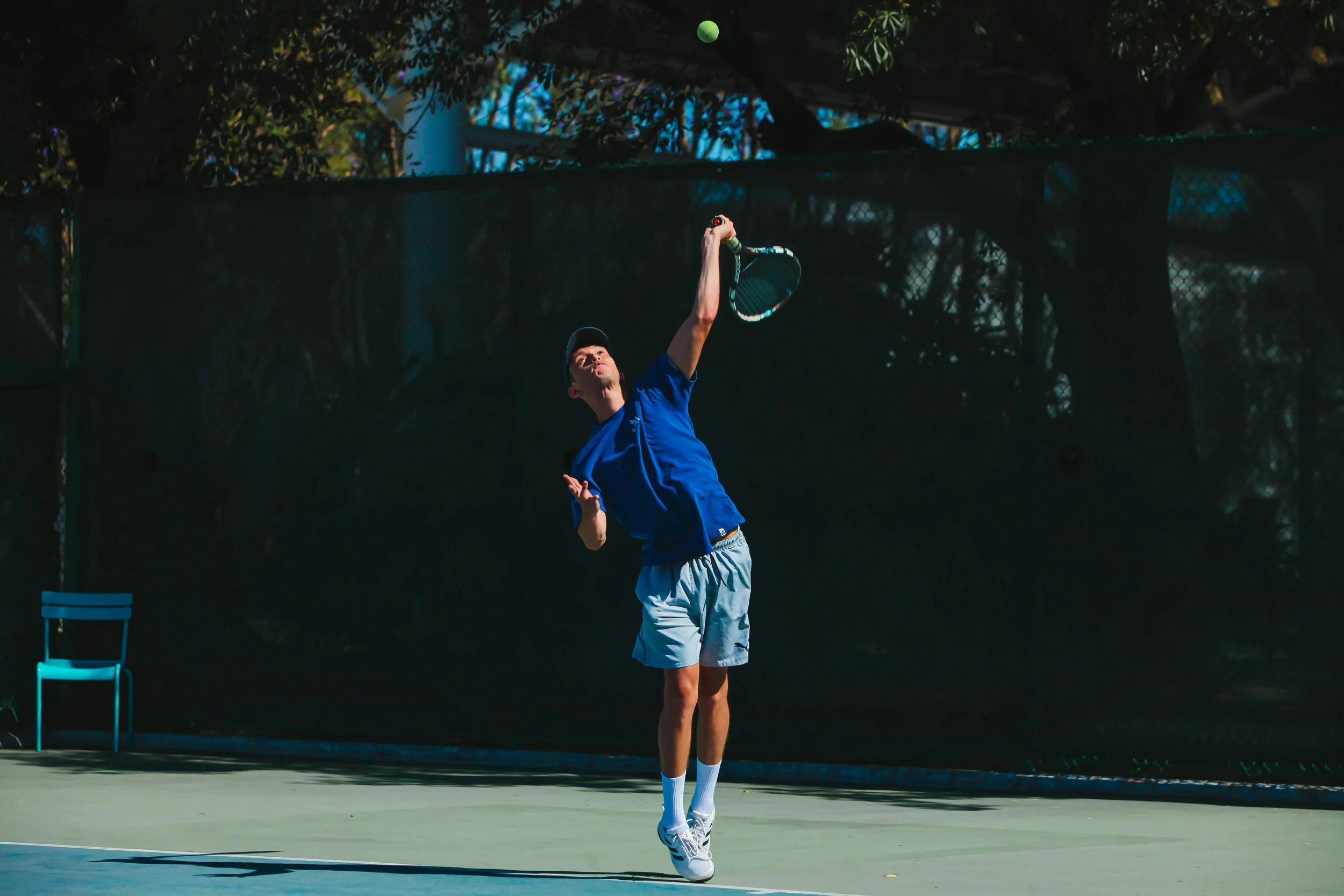 Man hitting a tennis serve