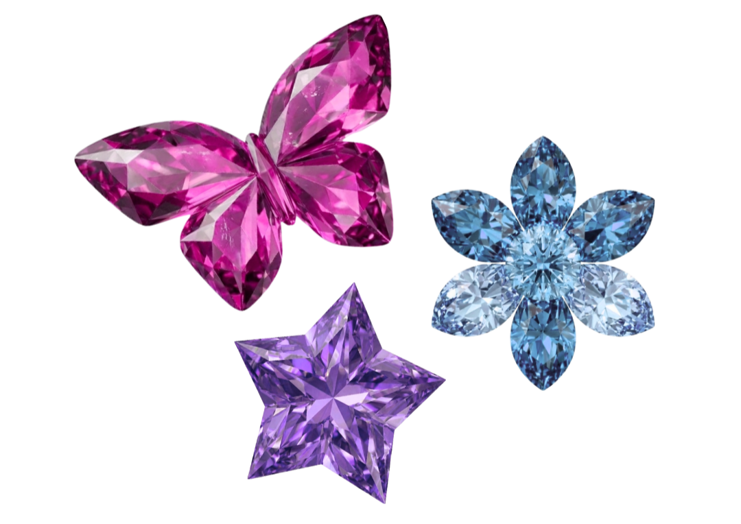 Three colorful gem-studded jewelry pieces in pink butterfly, purple star, and blue flower shapes.