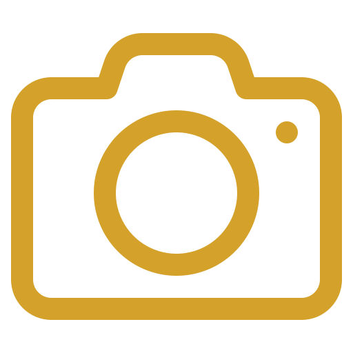 Placeholder icon of a camera in gold on a black background.