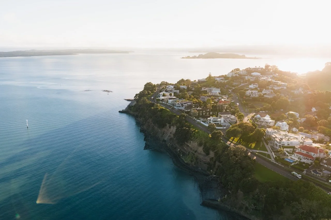 Aerial view of Auckland’s Eastern Bays coastline and Achilles Point, showing the exceptional coastal position of 20 Springcombe, in St Heliers. Set close to the waterfront with the Hauraki Gulf and Rangitoto beyond, the property sits within one of Au