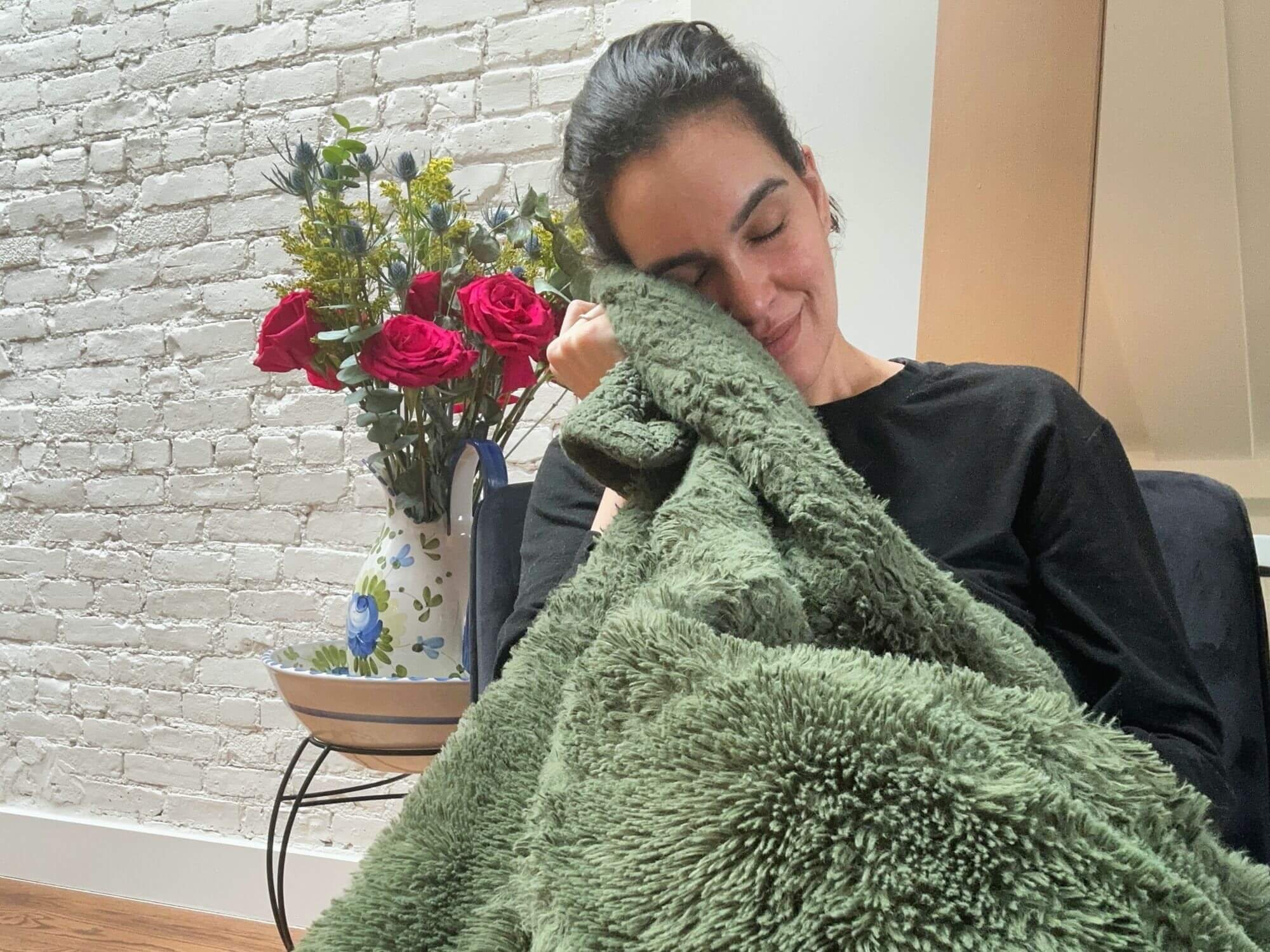 Dariana Casado - holding soft green blanket