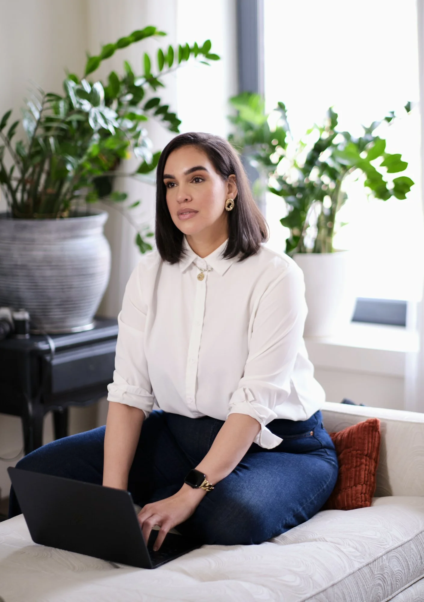 Dariana Casado - in jeans and white top surrounded by plants