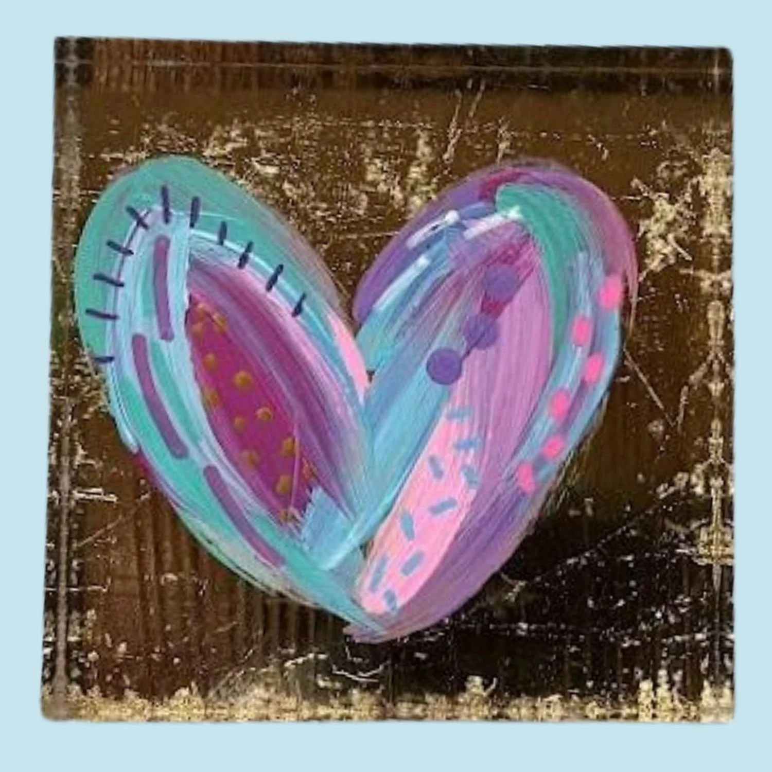 Artwork of a heart painted in pastel colors with decorative patterns on a dark, textured background.
