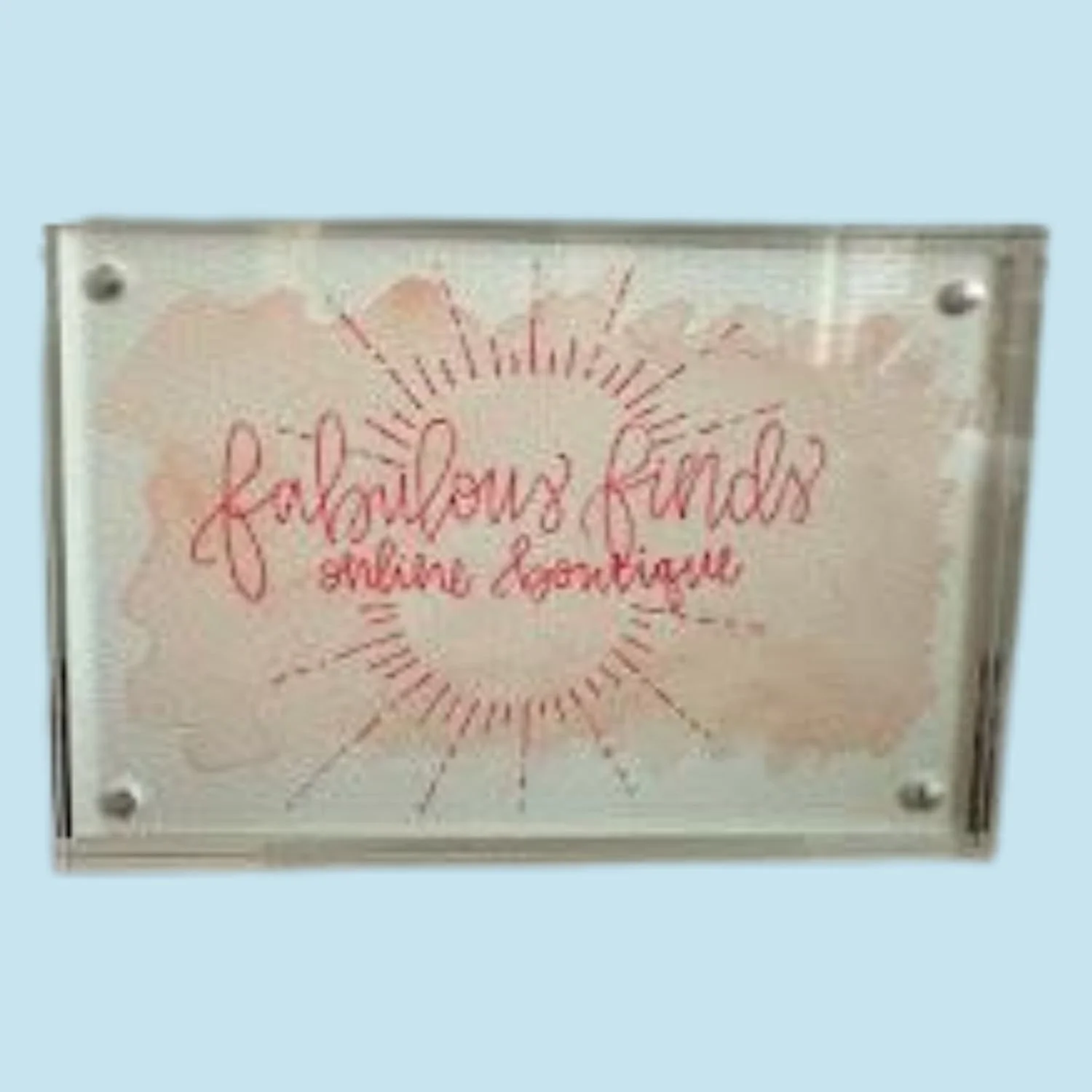 Decorative custom sign with a sunburst design around words.