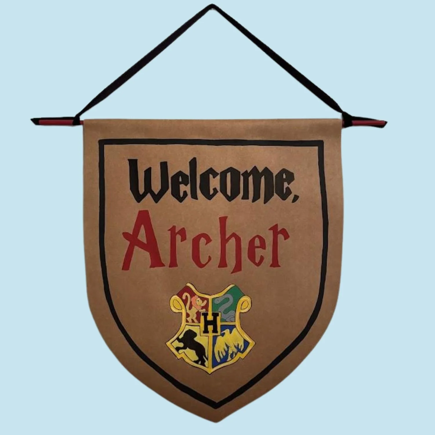 A custom decorative hanging banner with a Gryffindor crest at the bottom, displaying the text 'welcome, Archer' on a light blue background.