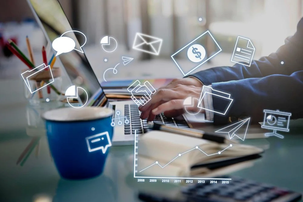 Person working on a laptop with digital icons representing communication, finance, documents, and data analysis floating around.