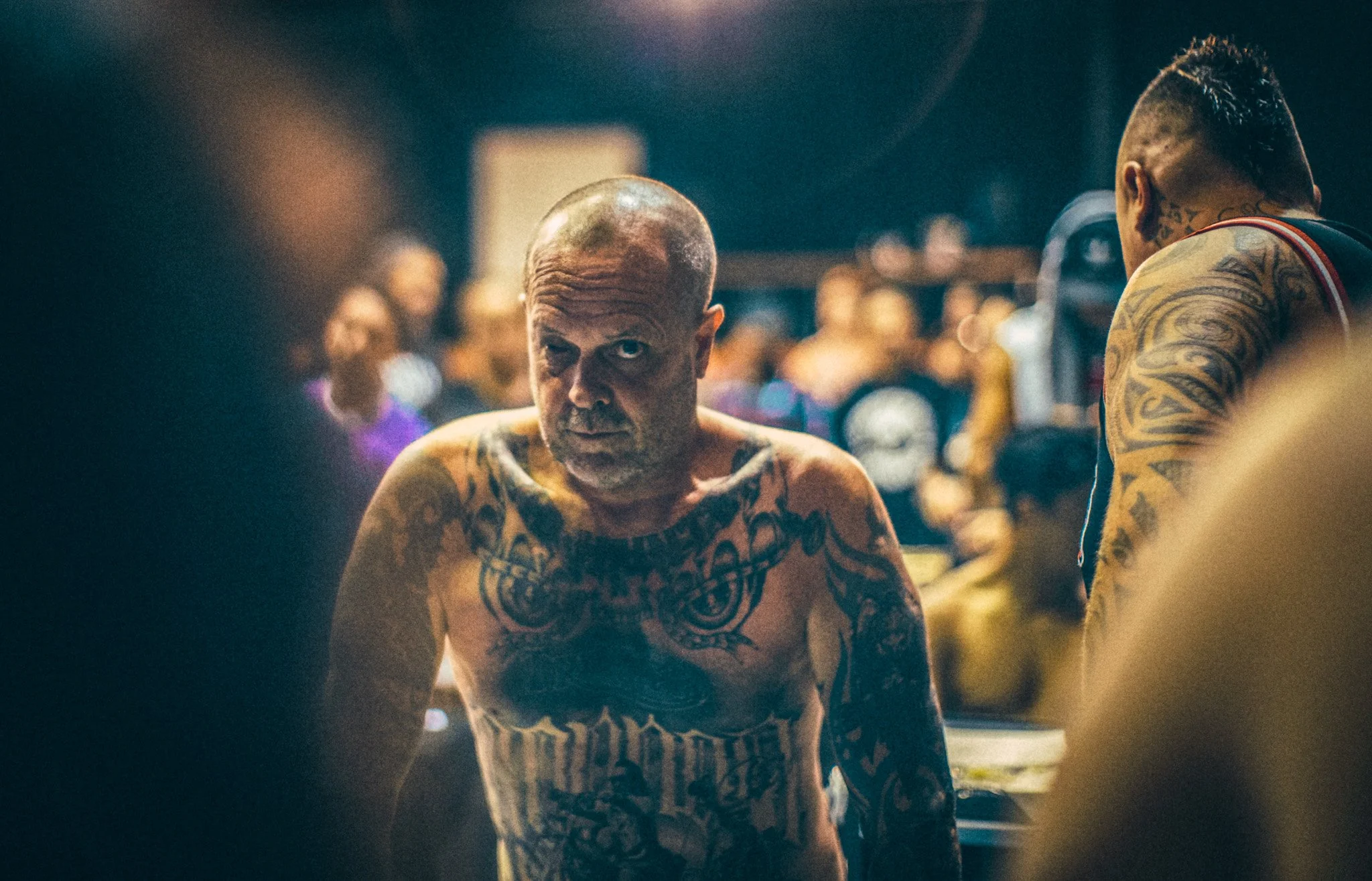 Editorial portrait heavily tattooed man crowd scene Simon Shattky
